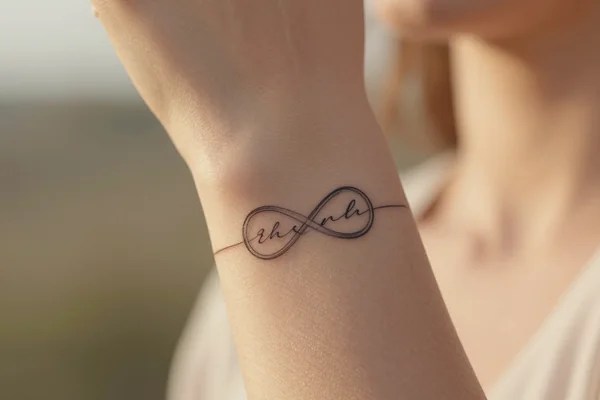 Couple tattoo: infinity + initials